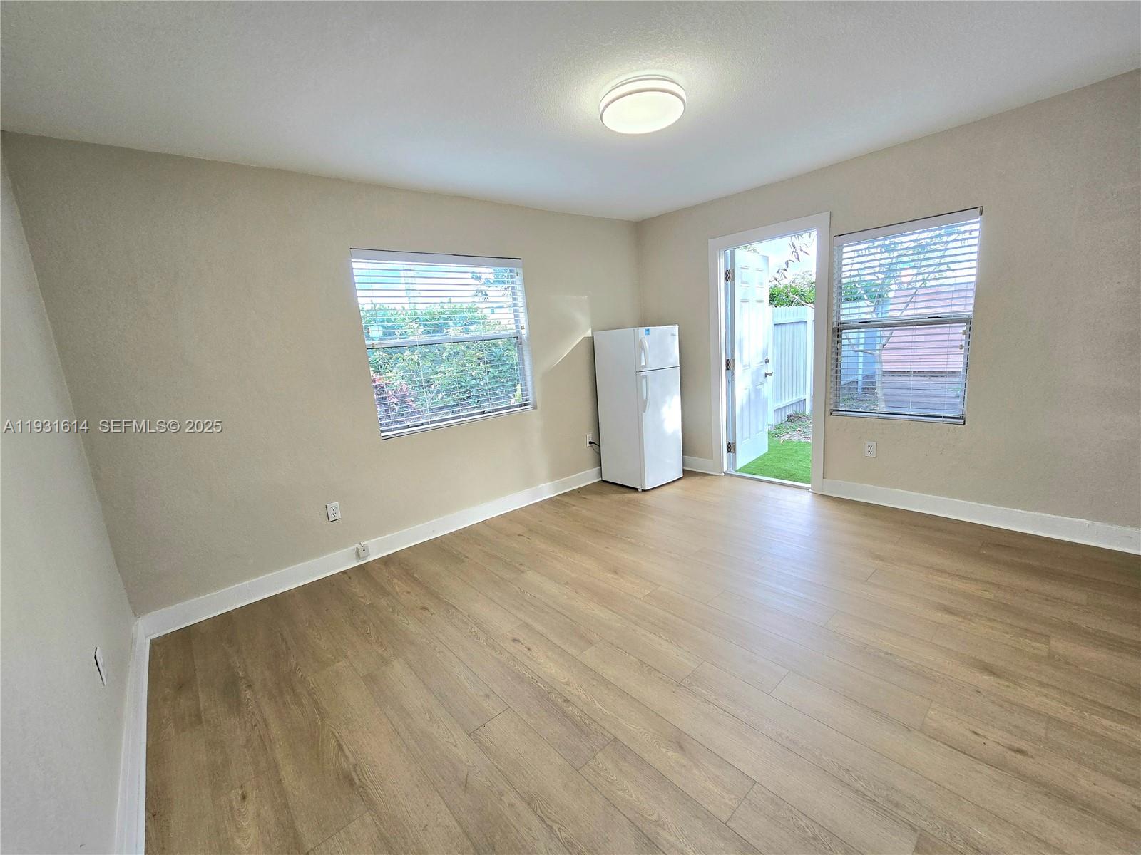 13340 Northeast 16th Avenue North Miami, FL 33161 - Photo 4 of 18 wooden floor in an empty room with a window