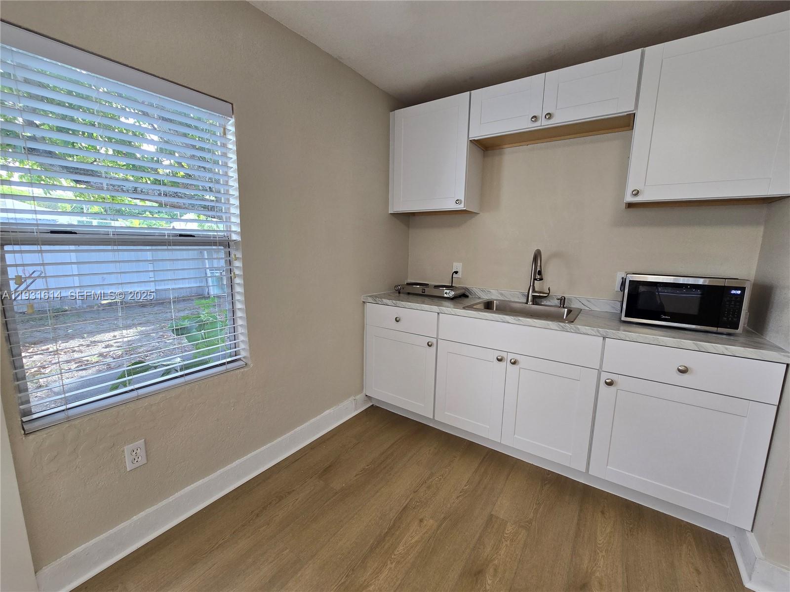 13340 Northeast 16th Avenue North Miami, FL 33161 - Photo 10 of 18 a kitchen with cabinets appliances a sink and a window