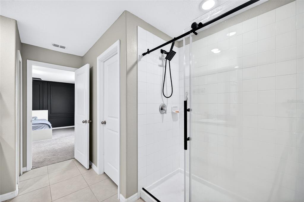 31724 Sun Kettle Loop Wesley Chapel, FL 33545 - Photo 15 of 49 a bathroom with a shower and a glass door