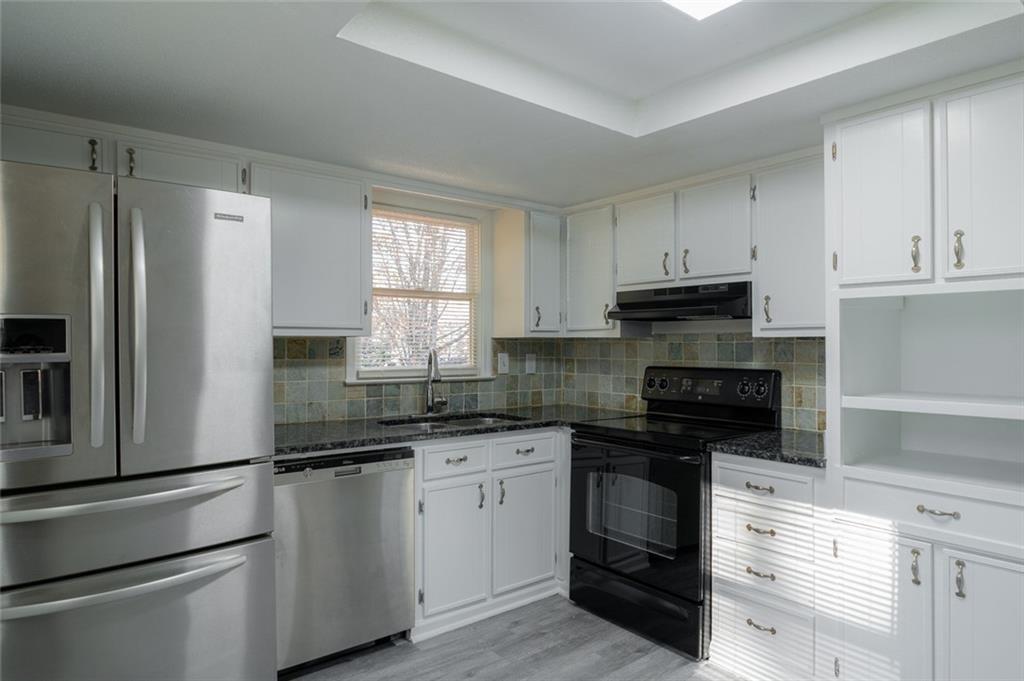3599 Lower Roswell Road Marietta, GA 30068 - Photo 14 of 34 a kitchen with cabinets stainless steel appliances and a window