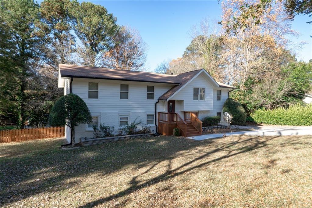 3599 Lower Roswell Road Marietta, GA 30068 - Photo 2 of 34 a view of a house with backyard and trees