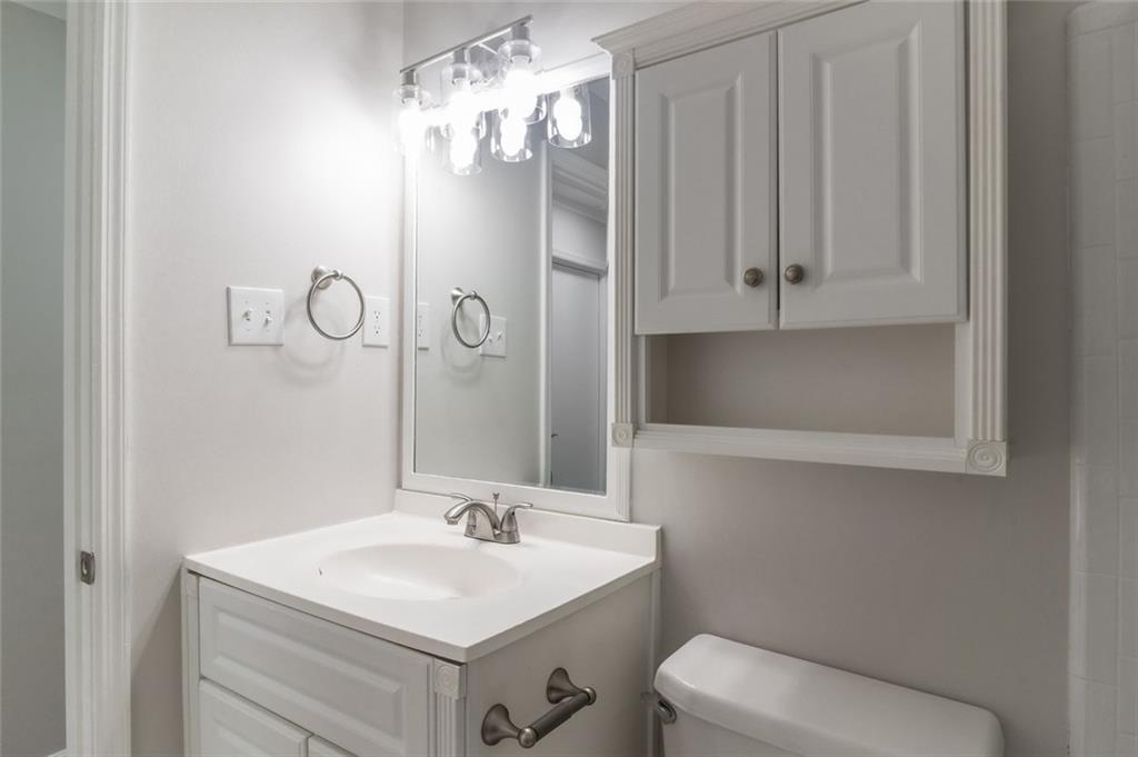 3599 Lower Roswell Road Marietta, GA 30068 - Photo 27 of 34 a bathroom with a toilet sink and mirror