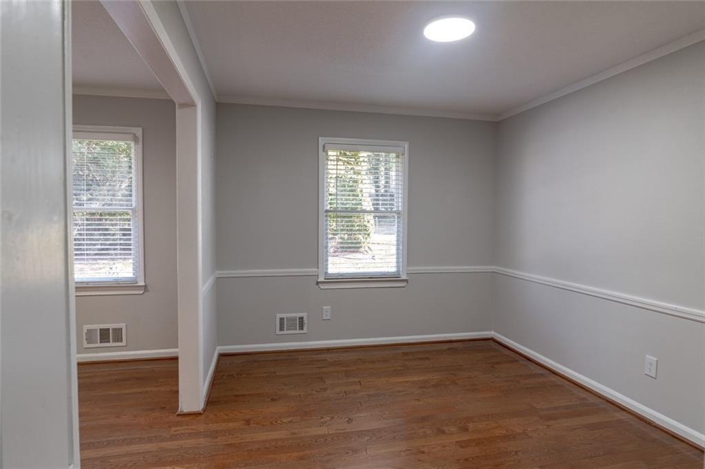 3599 Lower Roswell Road Marietta, GA 30068 - Photo 9 of 34 an empty room with wooden floor and windows