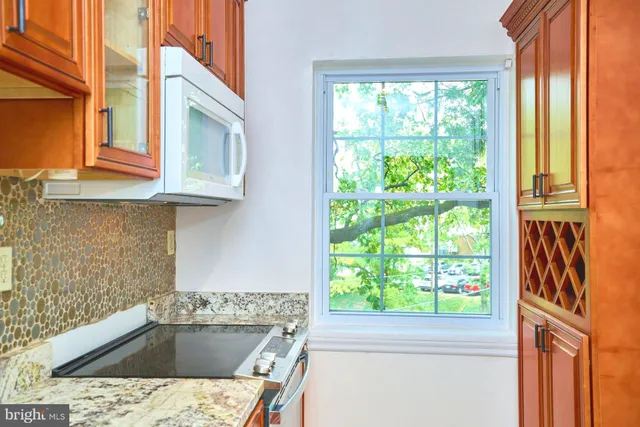 a kitchen with a sink window and cabinets