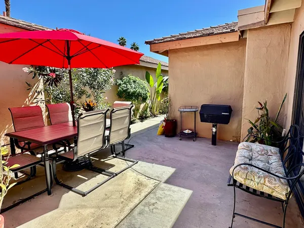 a view of a backyard with furniture and a tub