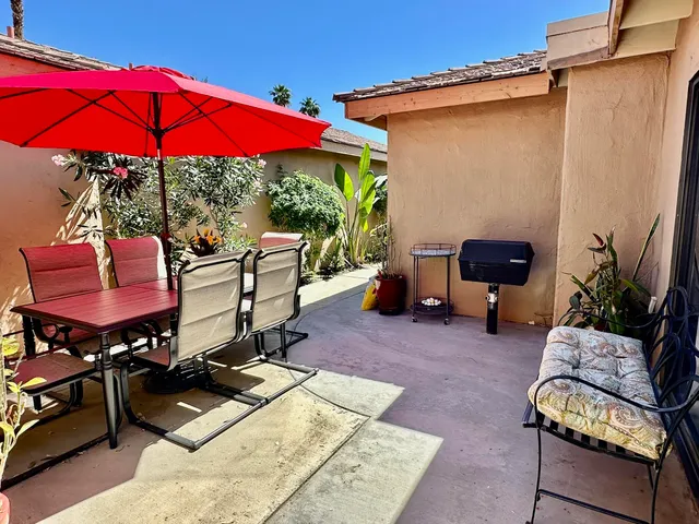 a view of a backyard with furniture and a tub