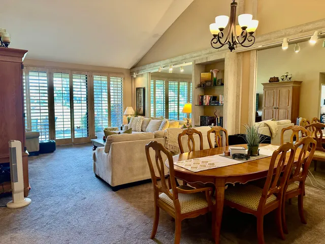 a view of a dining room with furniture wooden floor and chandelier