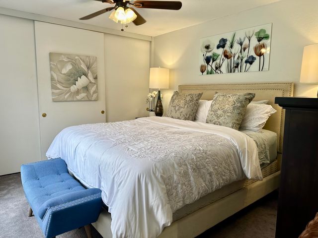 a bedroom with a bed and painting on the wall