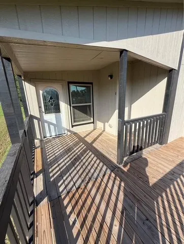 a balcony view with a wooden floor and outdoor space