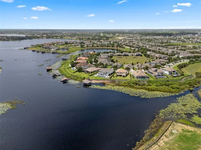 an aerial view of a house with a lake view