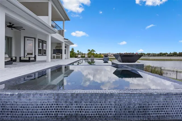 a front view of a house with swimming pool and sitting area