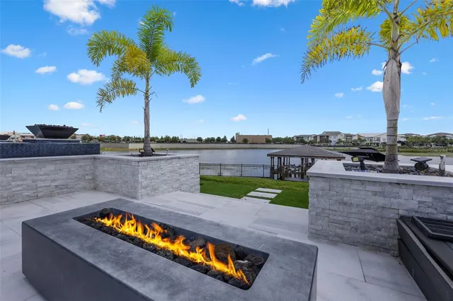 a view of a swimming pool with a table and chairs under an umbrella