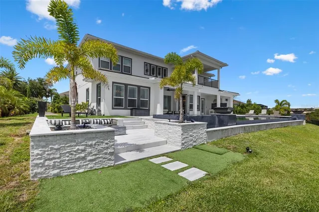 a view of swimming pool with seating space and yard in the back