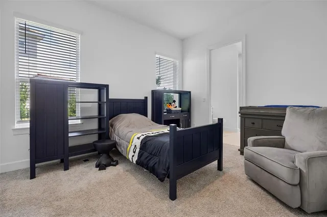 a kitchen with stainless steel appliances granite countertop a stove a sink a center island a dining table and chairs