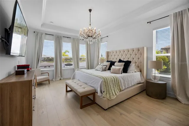 a view of a dining room with furniture and a chandelier