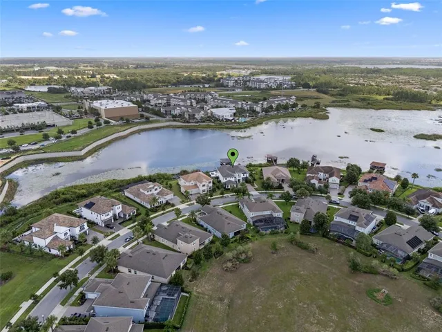 an aerial view of a house with a lake view