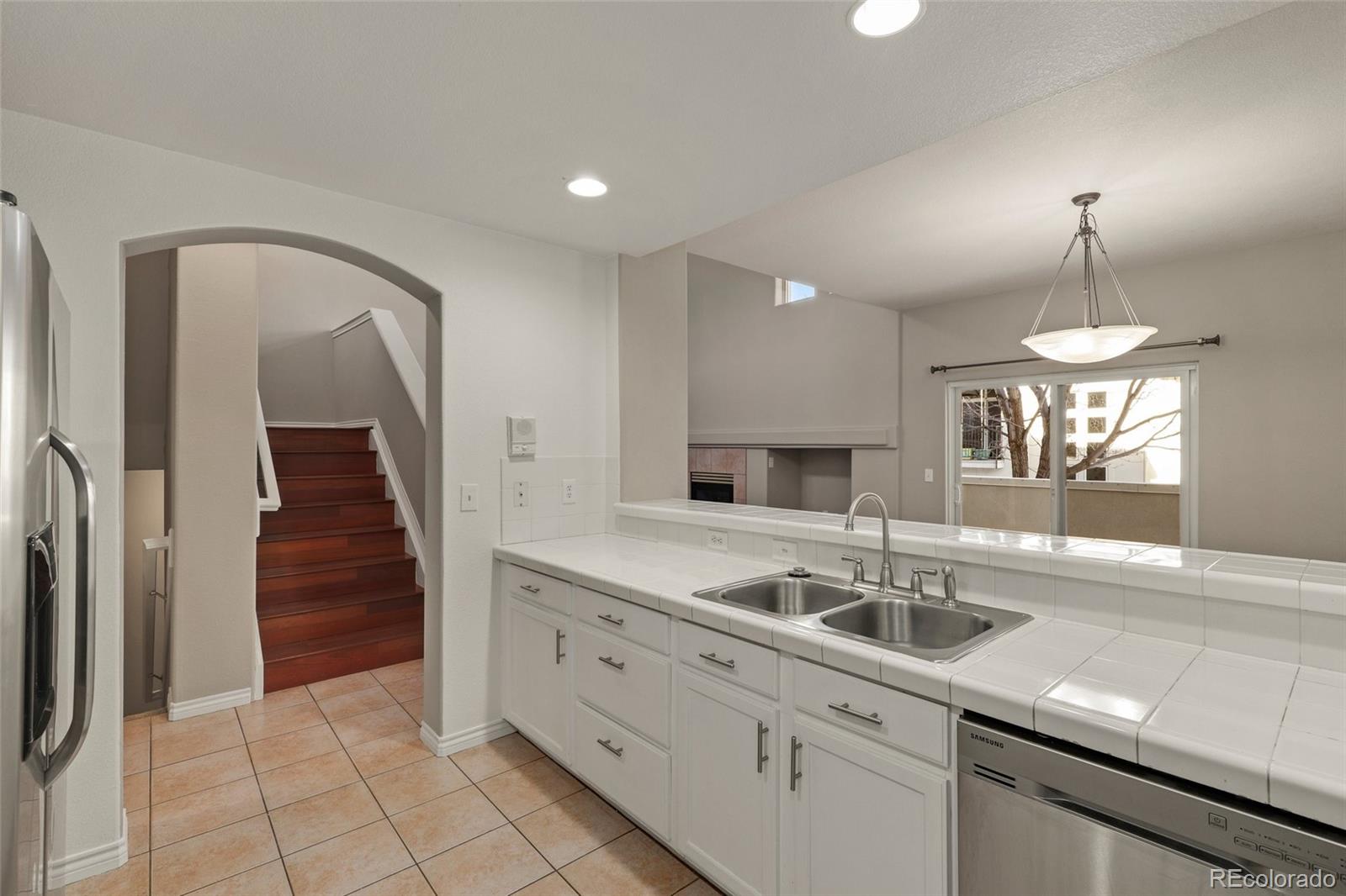 6677 South Forest Way, Unit D Centennial, CO 80121 - Photo 15 of 35 a kitchen with sink and mirror