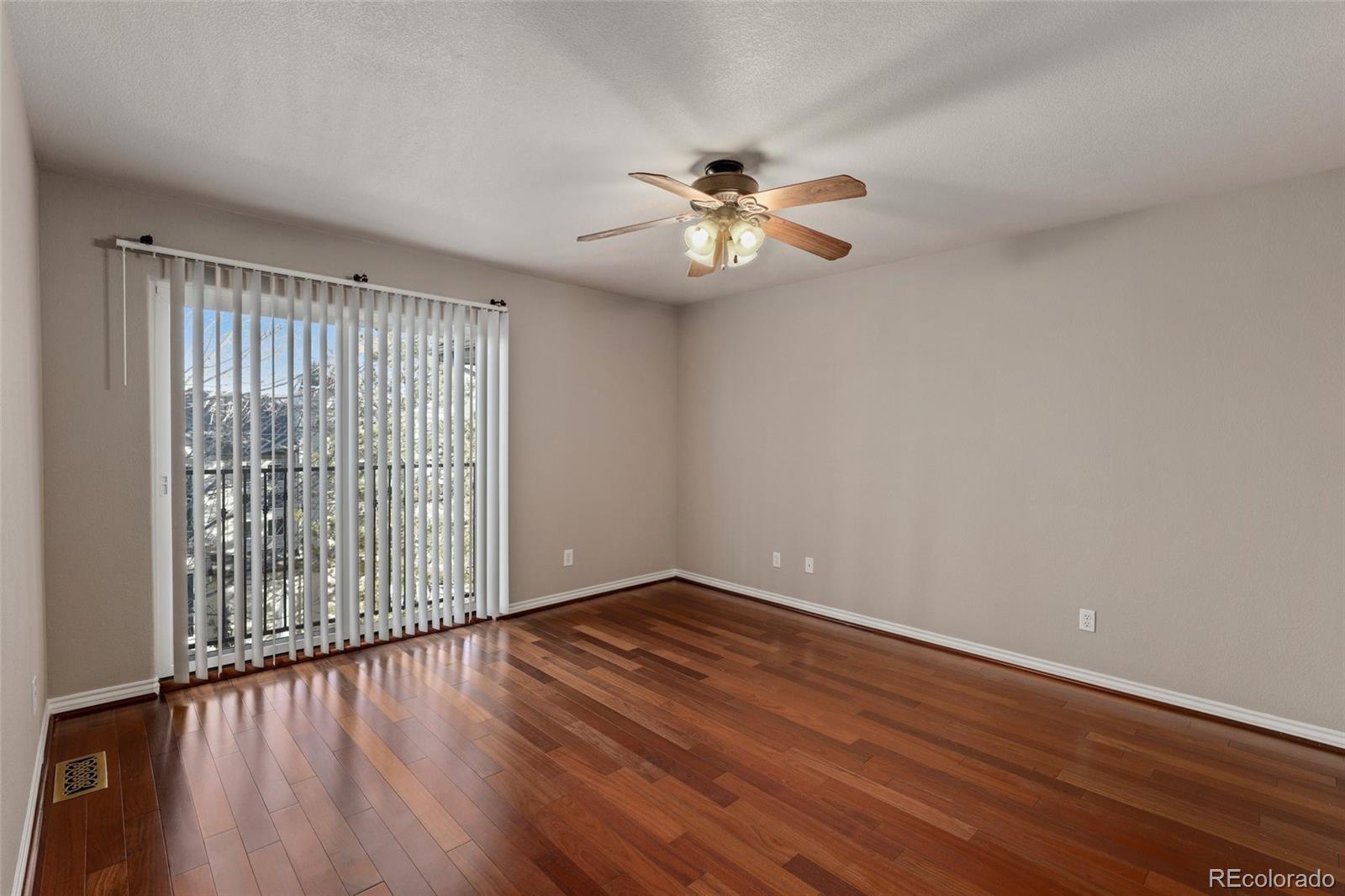 6677 South Forest Way, Unit D Centennial, CO 80121 - Photo 21 of 35 a view of empty room with wooden floor and fan