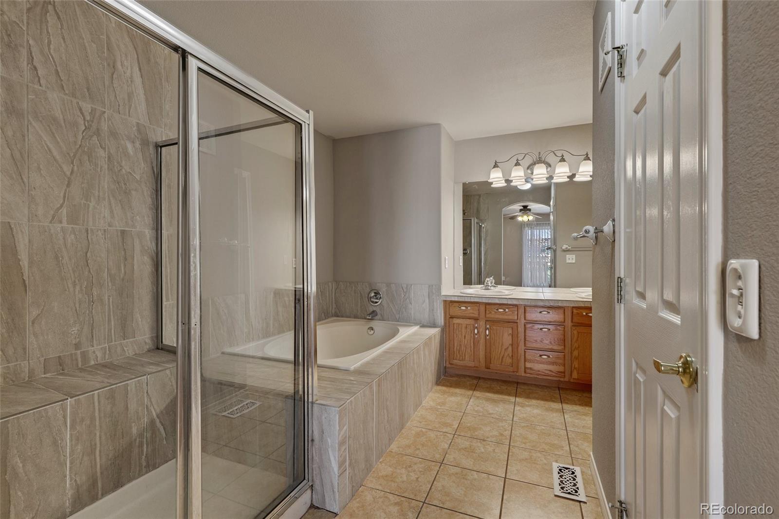 6677 South Forest Way, Unit D Centennial, CO 80121 - Photo 23 of 35 a spacious bathroom with a shower and a sink