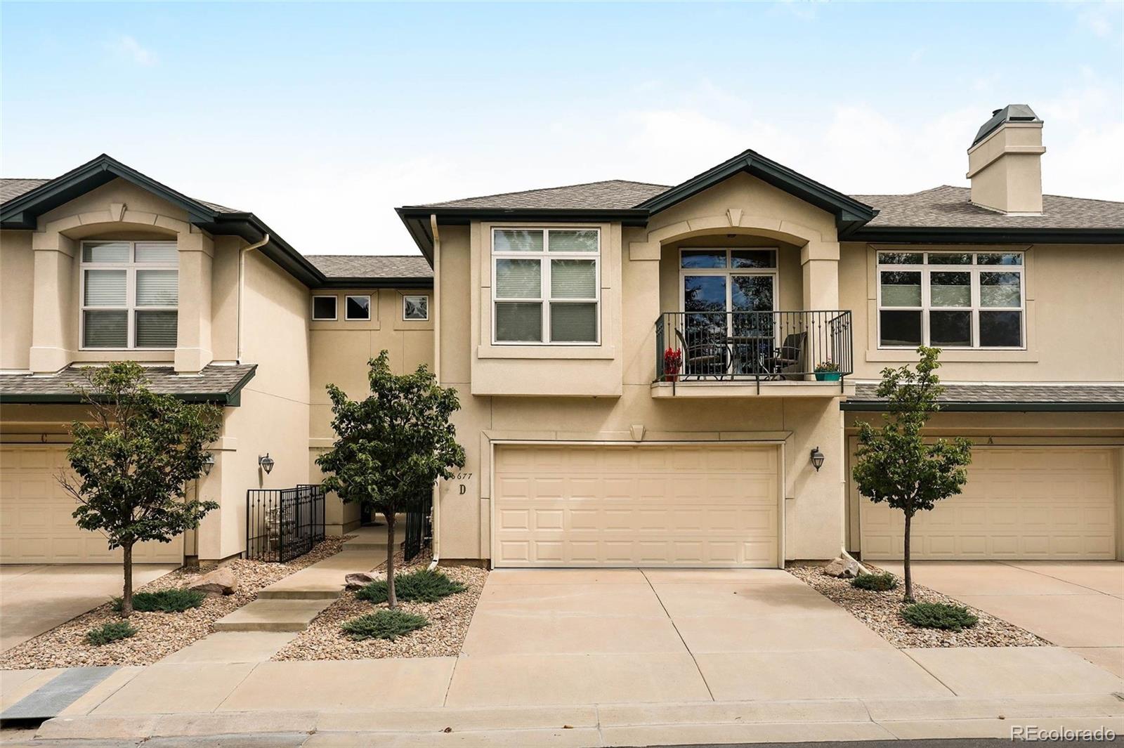 6677 South Forest Way, Unit D Centennial, CO 80121 - Photo 33 of 35 a front view of a house with garden