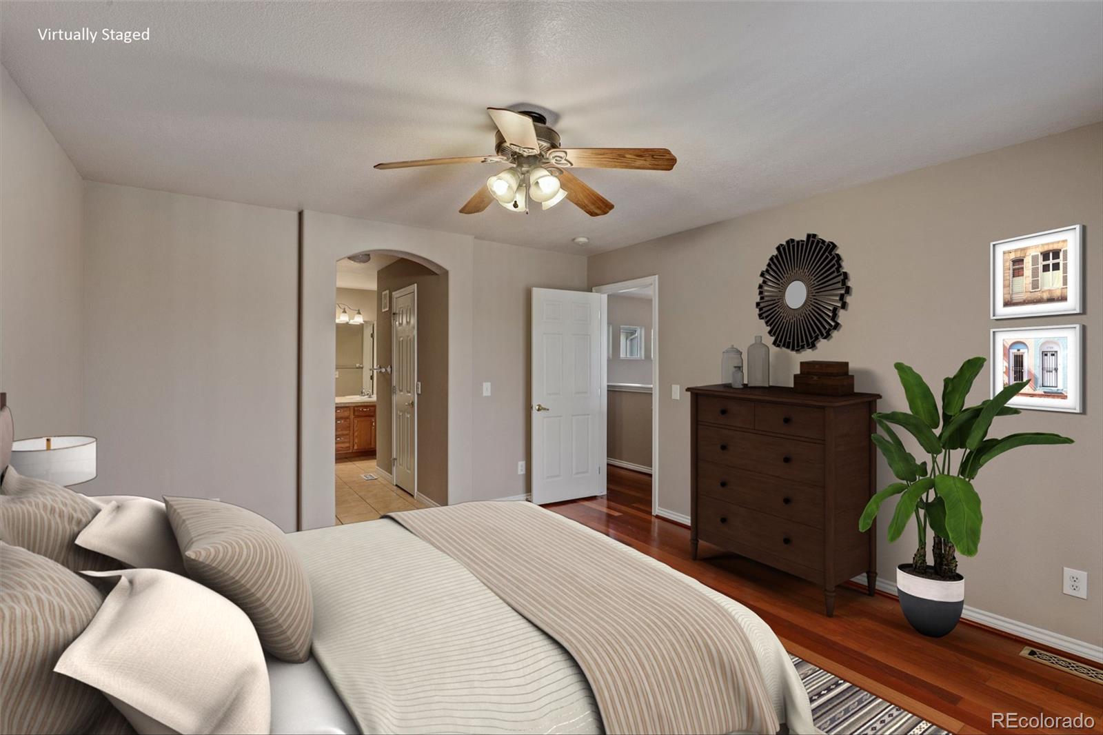 6677 South Forest Way, Unit D Centennial, CO 80121 - Photo 4 of 35 a bedroom with a bed and ceiling fan