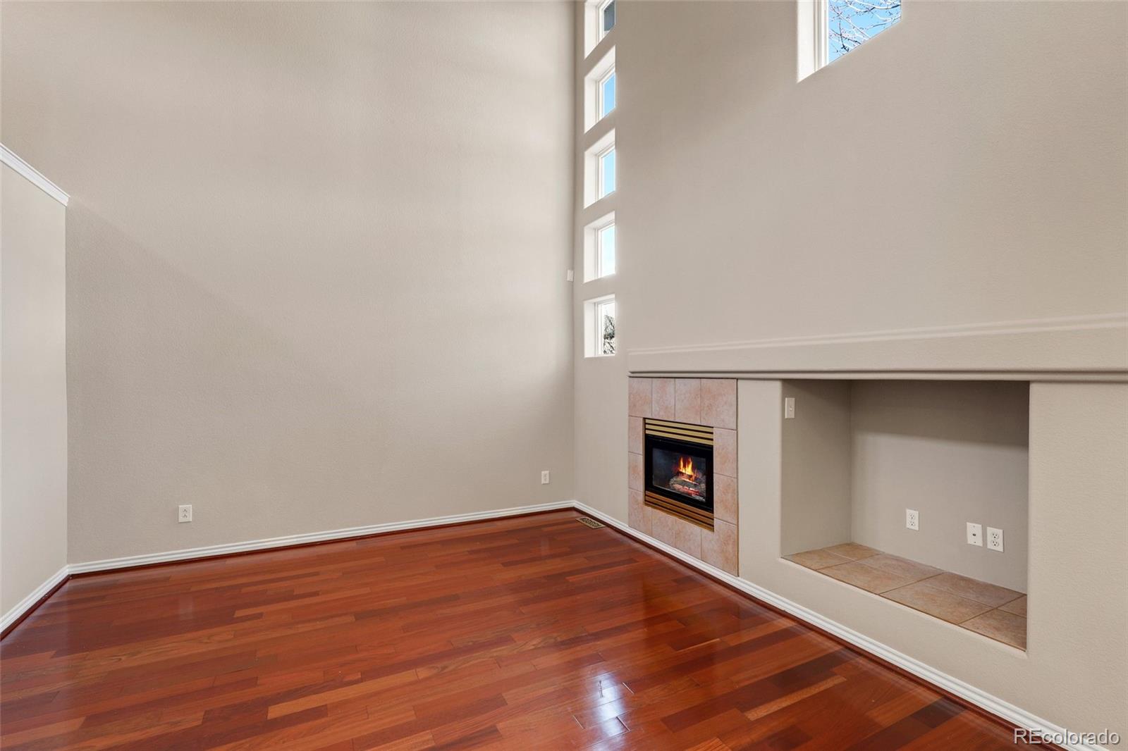 6677 South Forest Way, Unit D Centennial, CO 80121 - Photo 6 of 35 a view of an empty room with wooden floor and a window