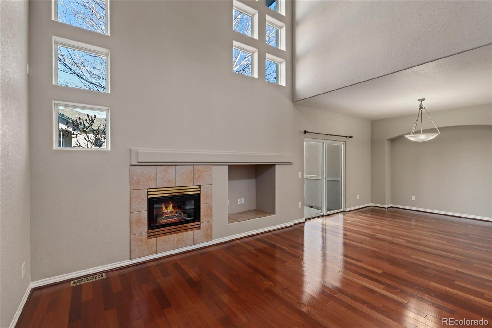 6677 South Forest Way, Unit D Centennial, CO 80121 - Photo 8 of 35 an empty room with windows and fireplace