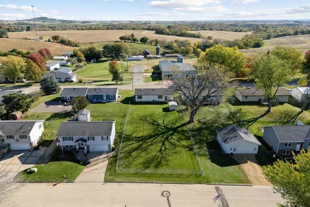 an aerial view of a house with yard swimming pool and ocean view