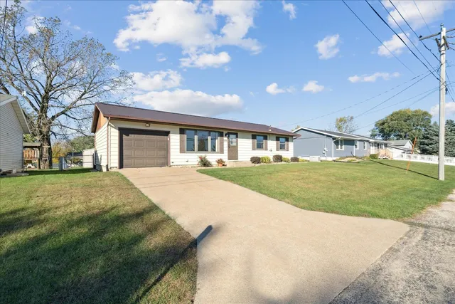a view of an house with backyard and road