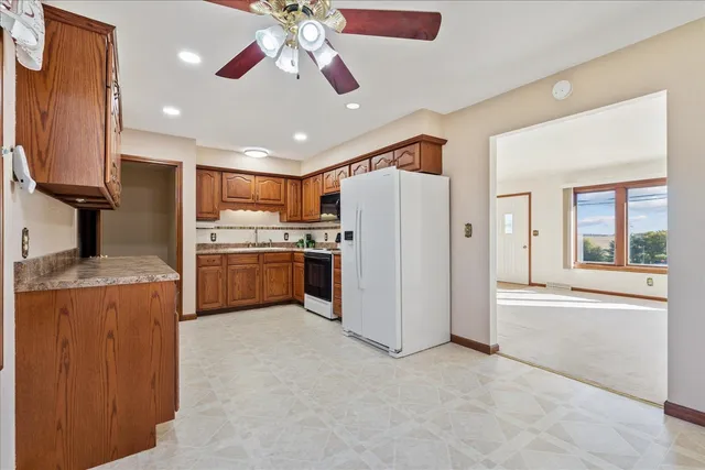 a kitchen with refrigerator and microwave