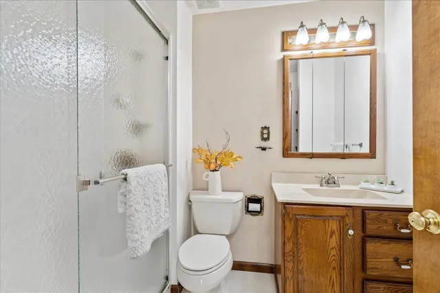 a bathroom with a sink vanity mirror and toilet