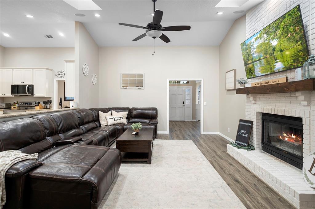 1777 Seneca Boulevard Winter Springs, FL 32708 - Photo 11 of 42 a living room with furniture a flat screen tv and a fireplace