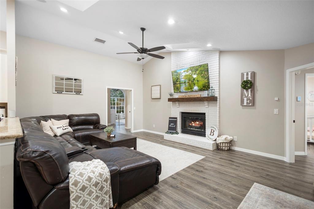 1777 Seneca Boulevard Winter Springs, FL 32708 - Photo 12 of 42 a living room with furniture a fireplace and a flat screen tv