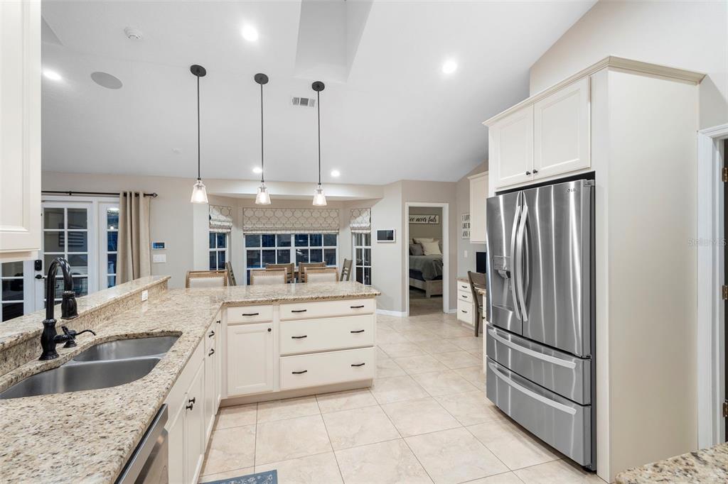 1777 Seneca Boulevard Winter Springs, FL 32708 - Photo 20 of 42 a large kitchen with kitchen island a stove a sink and a refrigerator