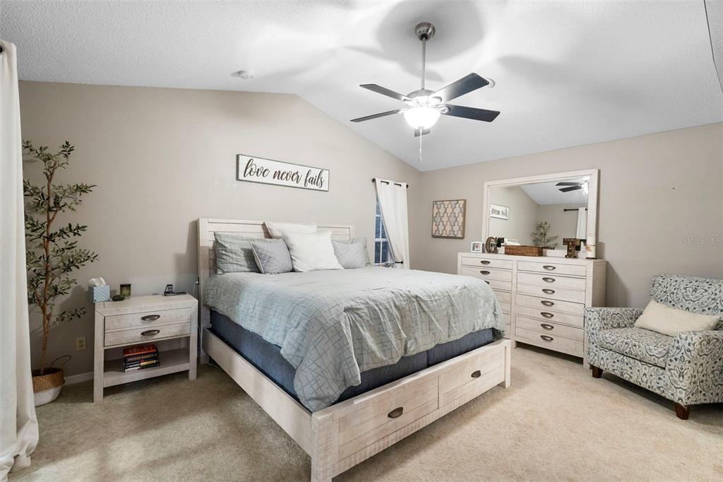 1777 Seneca Boulevard Winter Springs, FL 32708 - Photo 21 of 42 a spacious bedroom with a bed and a chandelier