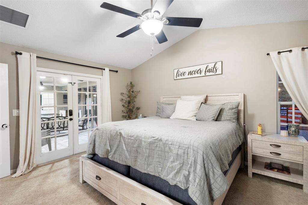 1777 Seneca Boulevard Winter Springs, FL 32708 - Photo 22 of 42 a spacious bedroom with a bed and a chandelier