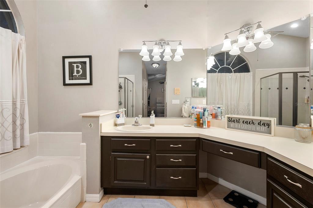 1777 Seneca Boulevard Winter Springs, FL 32708 - Photo 26 of 42 a spacious bathroom with a granite countertop sink a large mirror and shower