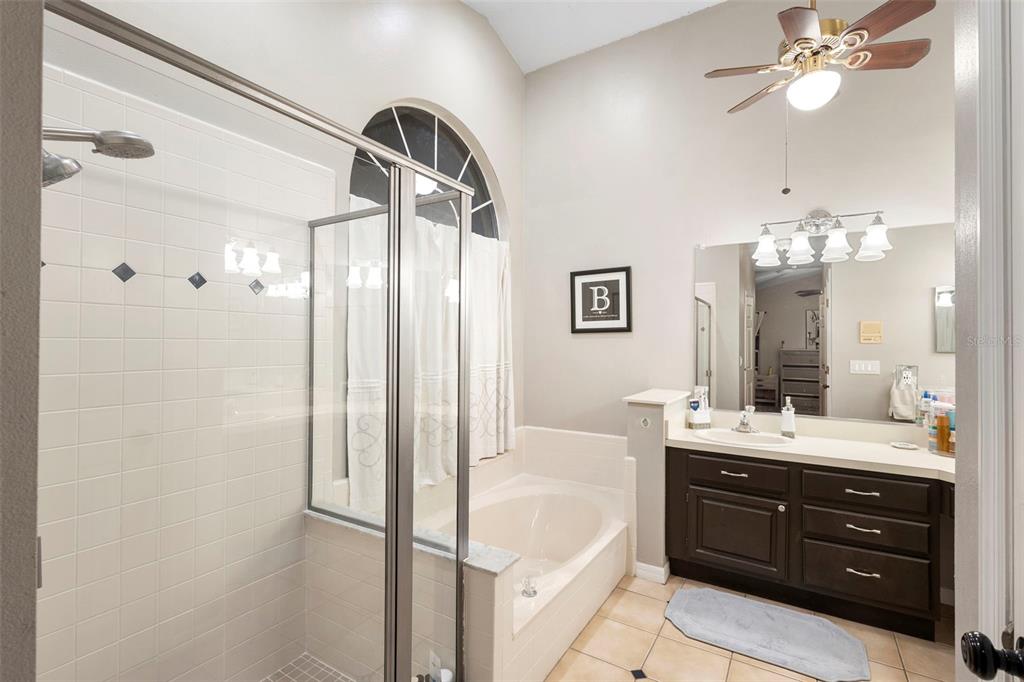1777 Seneca Boulevard Winter Springs, FL 32708 - Photo 27 of 42 a bathroom with a double vanity sink a large mirror and a bathtub