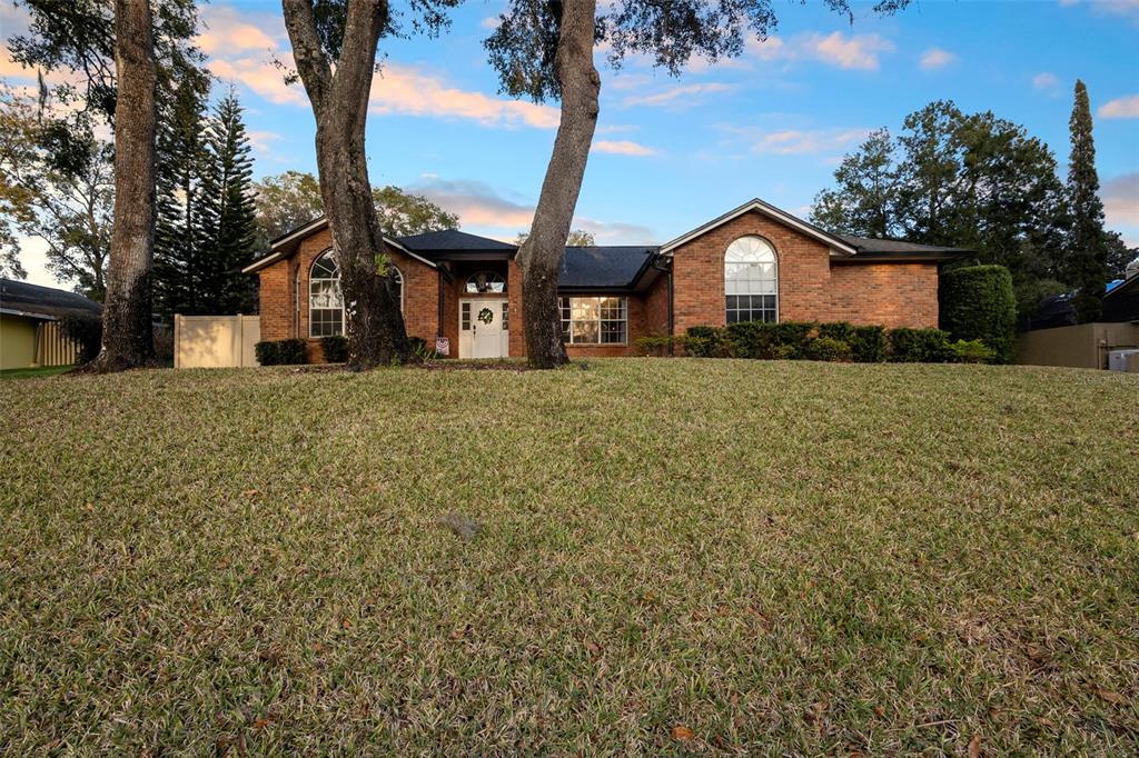 1777 Seneca Boulevard Winter Springs, FL 32708 - Photo 40 of 42 a front view of a house with a yard and garage