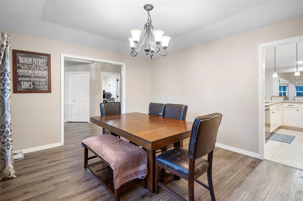 1777 Seneca Boulevard Winter Springs, FL 32708 - Photo 6 of 42 a view of a dining room with furniture and wooden floor