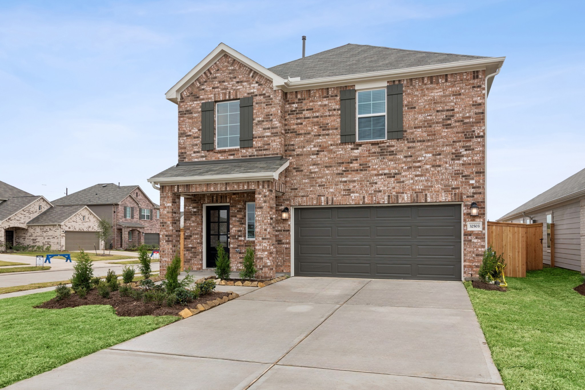 32503 Midsummer Drive Fulshear, TX 77441 - Photo 1 of 48 a front view of a house with garden