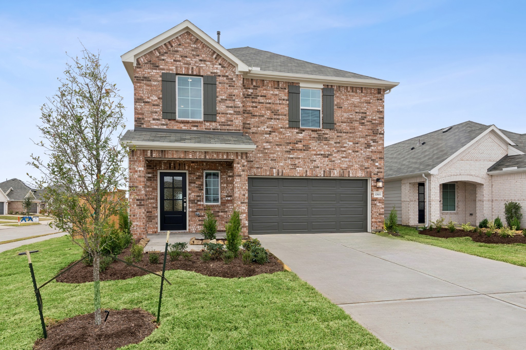 32503 Midsummer Drive Fulshear, TX 77441 - Photo 11 of 48 a front view of a house with garden
