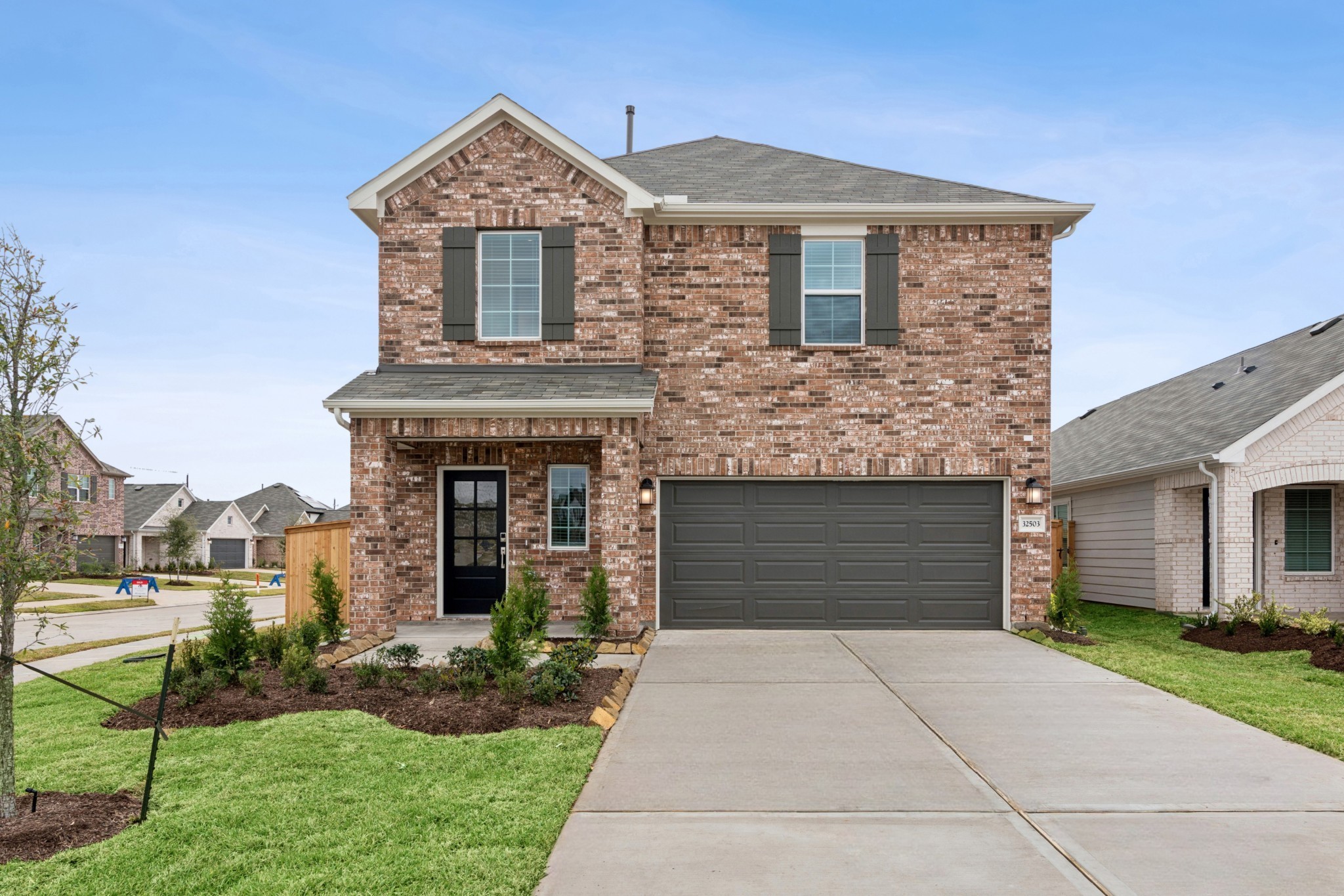 32503 Midsummer Drive Fulshear, TX 77441 - Photo 12 of 48 a front view of a house with a yard and garage