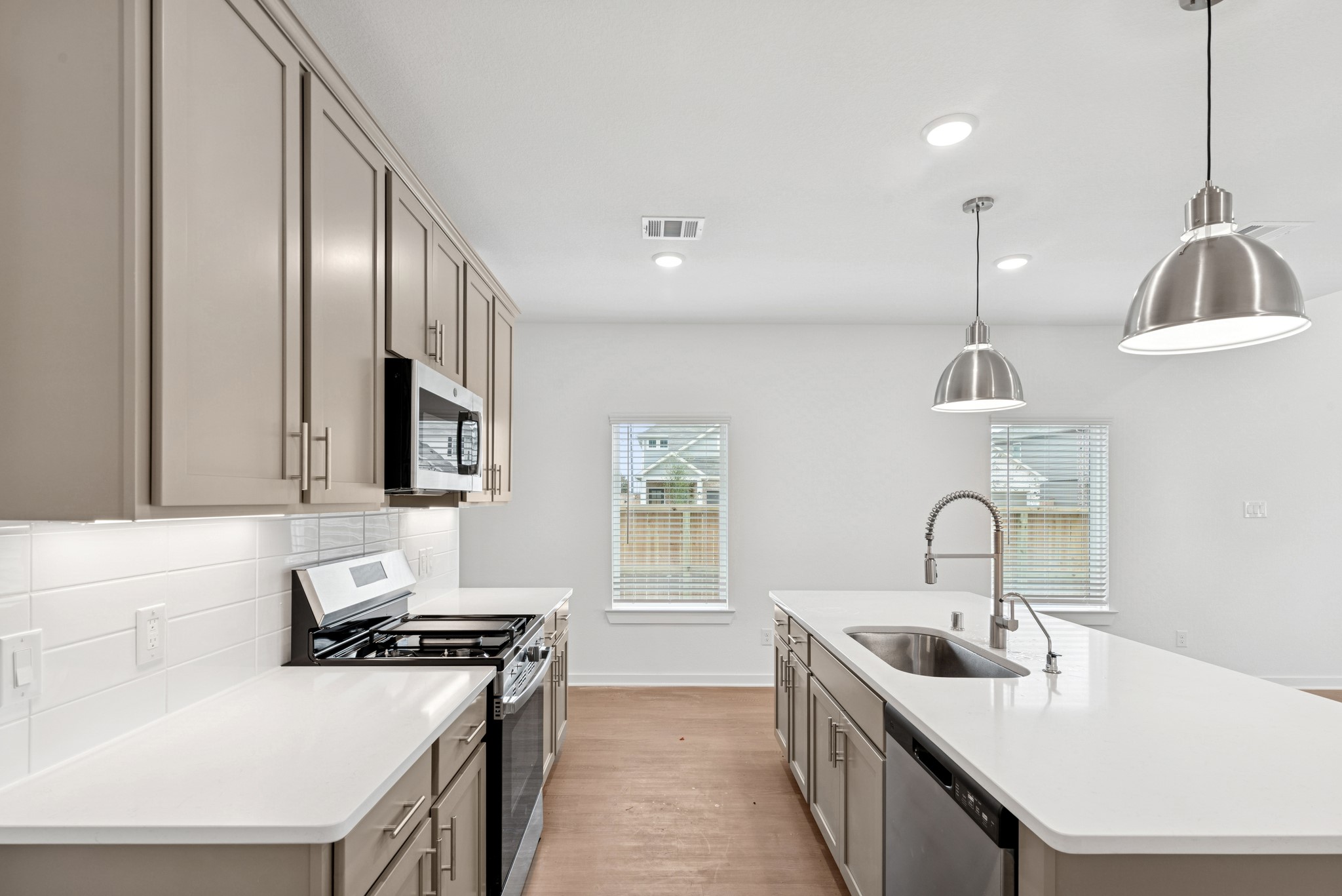32503 Midsummer Drive Fulshear, TX 77441 - Photo 18 of 48 a kitchen with stainless steel appliances granite countertop a sink stove and cabinets