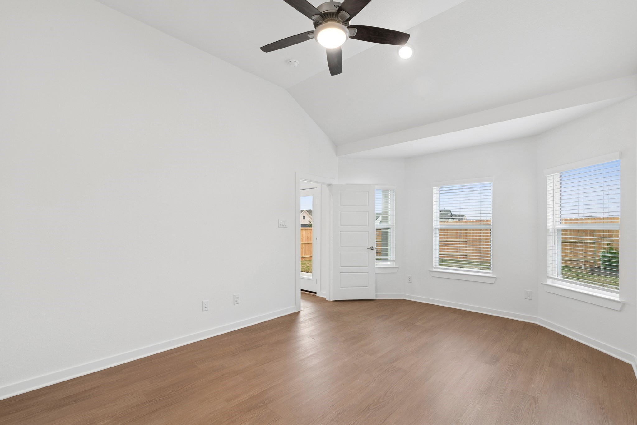 32503 Midsummer Drive Fulshear, TX 77441 - Photo 23 of 48 an empty room with wooden floor fan and windows