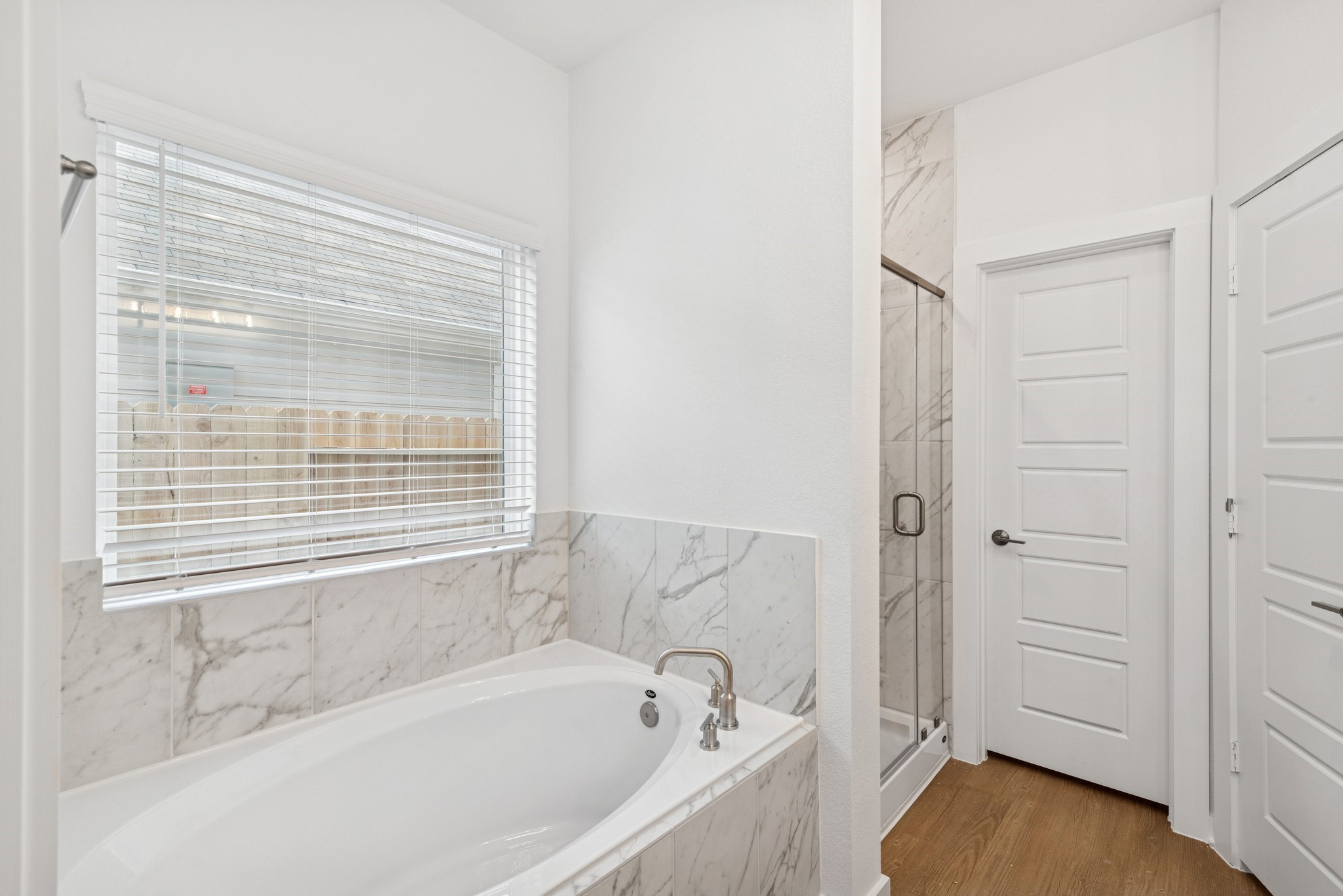 32503 Midsummer Drive Fulshear, TX 77441 - Photo 26 of 48 a bathroom with a bathtub and a shower