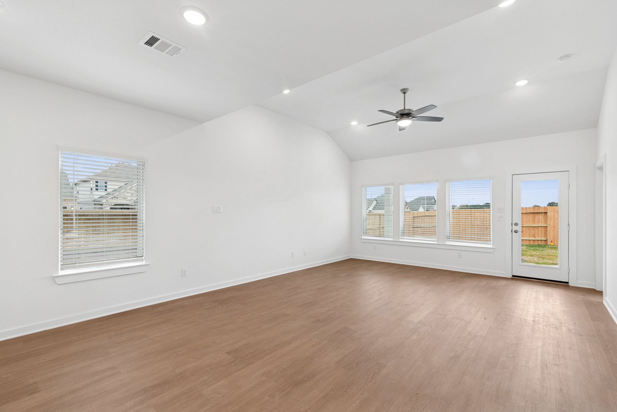 32503 Midsummer Drive Fulshear, TX 77441 - Photo 3 of 48 a view of an empty room with a window and wooden floor