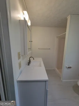 a bathroom with a sink a mirror and shower