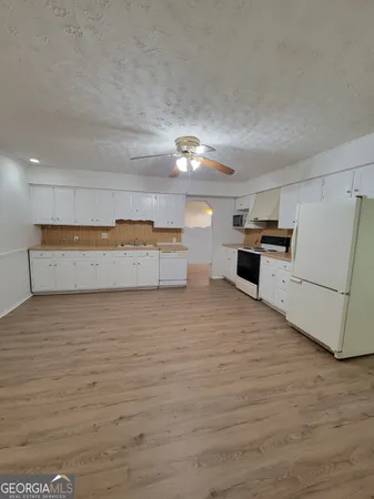 a view of kitchen and wooden floor