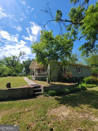 a front view of a house with garden